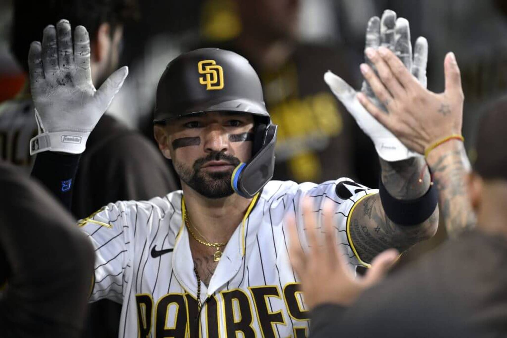 Nick Castellanos of the San Diego Padres is congratulated in the dugout after scoring a run at Petco Park in San Diego, California.
