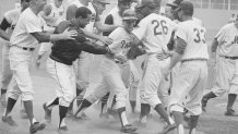 (Original Caption) Phillies outfielder Johnny Callison is mobbed by his National League teammates after he hit a ninth inning home run to break the 4-4 tie in the All-Star game here July 7th, to give the win to the National League by a score of 7-4. Shown left to right in the foreground are: Walt Alston, National League manager; winning pitcher Juan Marichal (wearing jacket); Callison; Billy Williams (26), who also homered in the game; and Ron Hunt (33), who singled in the game.