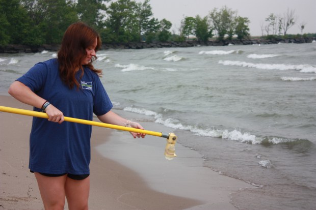 An Erie County Health Department intern is collecting and analyzing water samples at a local bathing beach. (Courtesy of Erie County Health Department)
