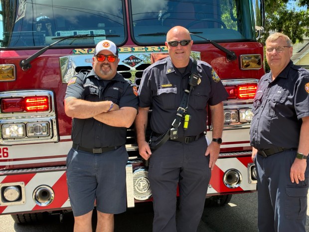 Narberth Fire Department Chief Fran Dixon and NFD's Bill Henderson stand with Edwin Walker who answered the call and took the wheel for the rousing ride around the Borough and up to Saint Margaret School on Friday, May 29. (Photo submitted by Mary Brown)