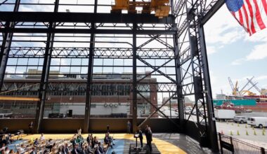 Pennsylvania Governor Josh Shapiro speaking from a podium at Urban Outfitters, Inc.