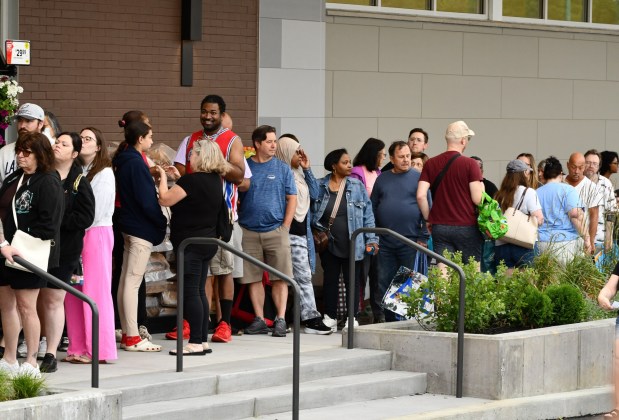Shoppers lined up in droves to take advantage of the early bird grocery giveaways. (Photo by Rick Cawley)