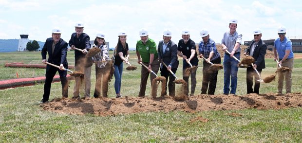 Reading Regional Airport Director Zackary Tempesco, center, breaks ground with state and local officials and construction personnel during a ceremony for the West Apron Hangar Development Project at the airport in Bern Township on Thursday, June 25, 2026. (BILL UHRICH/READING EAGLE)