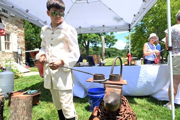 Ben Zachaarias, 13, of Wyomissing, forges a shepherd's hook during the Americana Fest at the Berks County Heritage Center in Bern Township on Saturday, June 20, 2026. (BILL UHRICH/READING EAGLE)