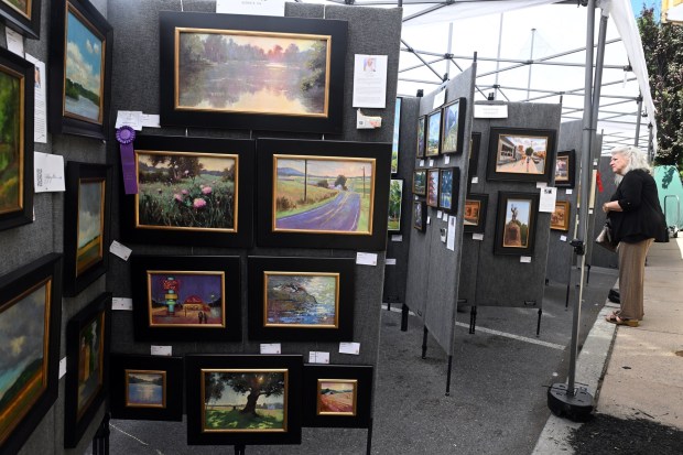 Festivalgoers pick vote for their favorite plein air artists during Art on the Avenue in West Reading on Saturday, June 20, 2026.    (BILL UHRICH/READING EAGLE)