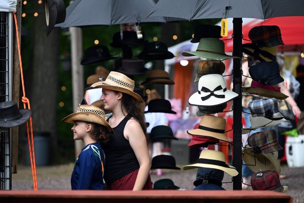 Festivalgoers try on hats during the Berks Celtic Fest. (BILL UHRICH/READING EAGLE)