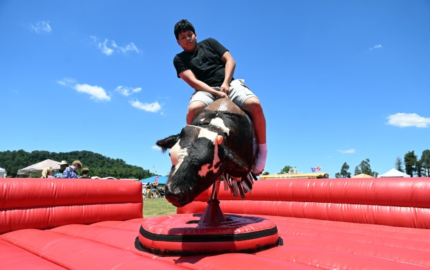 Christian Vasquez, 16, tries some bull riding during the Spring Fiesta at Jim Dietrich Park in Muhlenberg Township on Saturday, June 13, 2026. (BILL UHRICH/READING EAGLE)