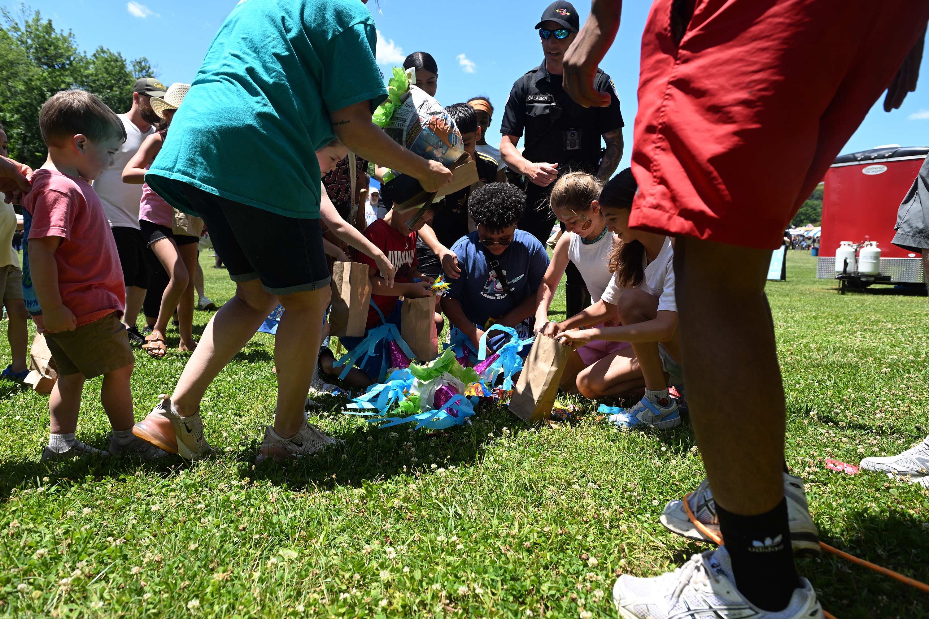 Children rush to pick up candy from the broken pinata...