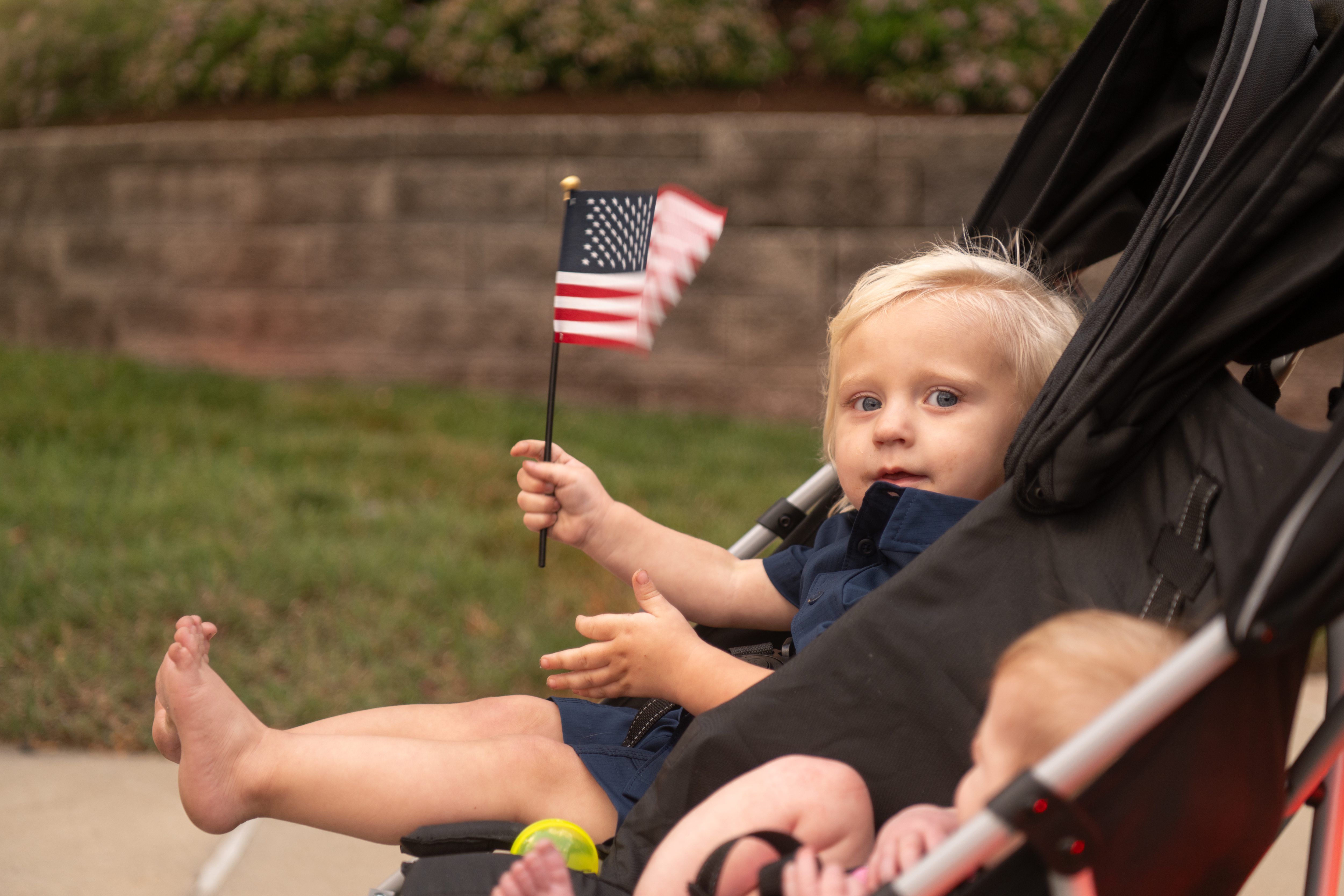 Keegan Lerch, 1, waves a flag by the side of...
