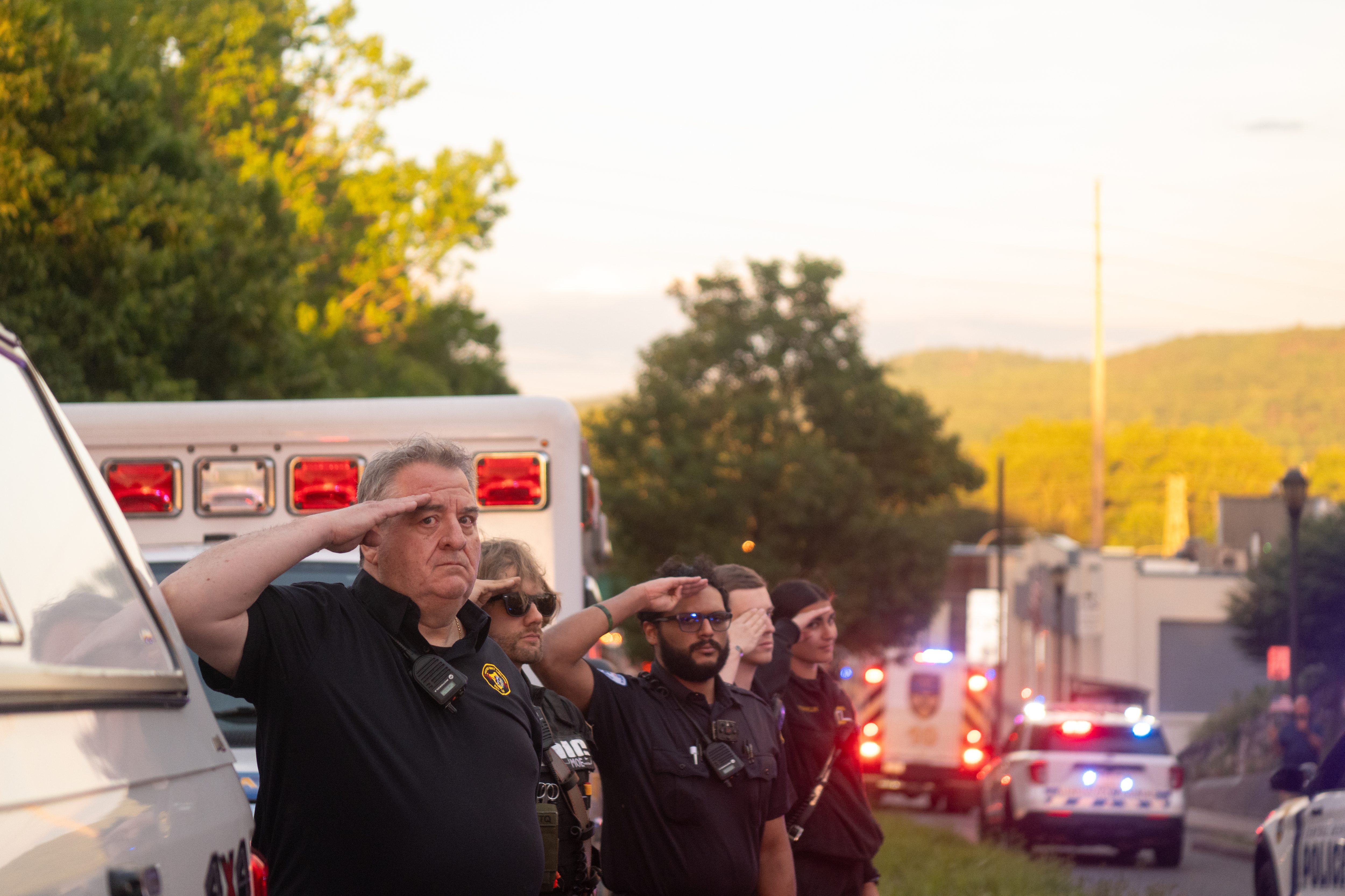 Members of Western Berks EMS salute as the procession escorting...