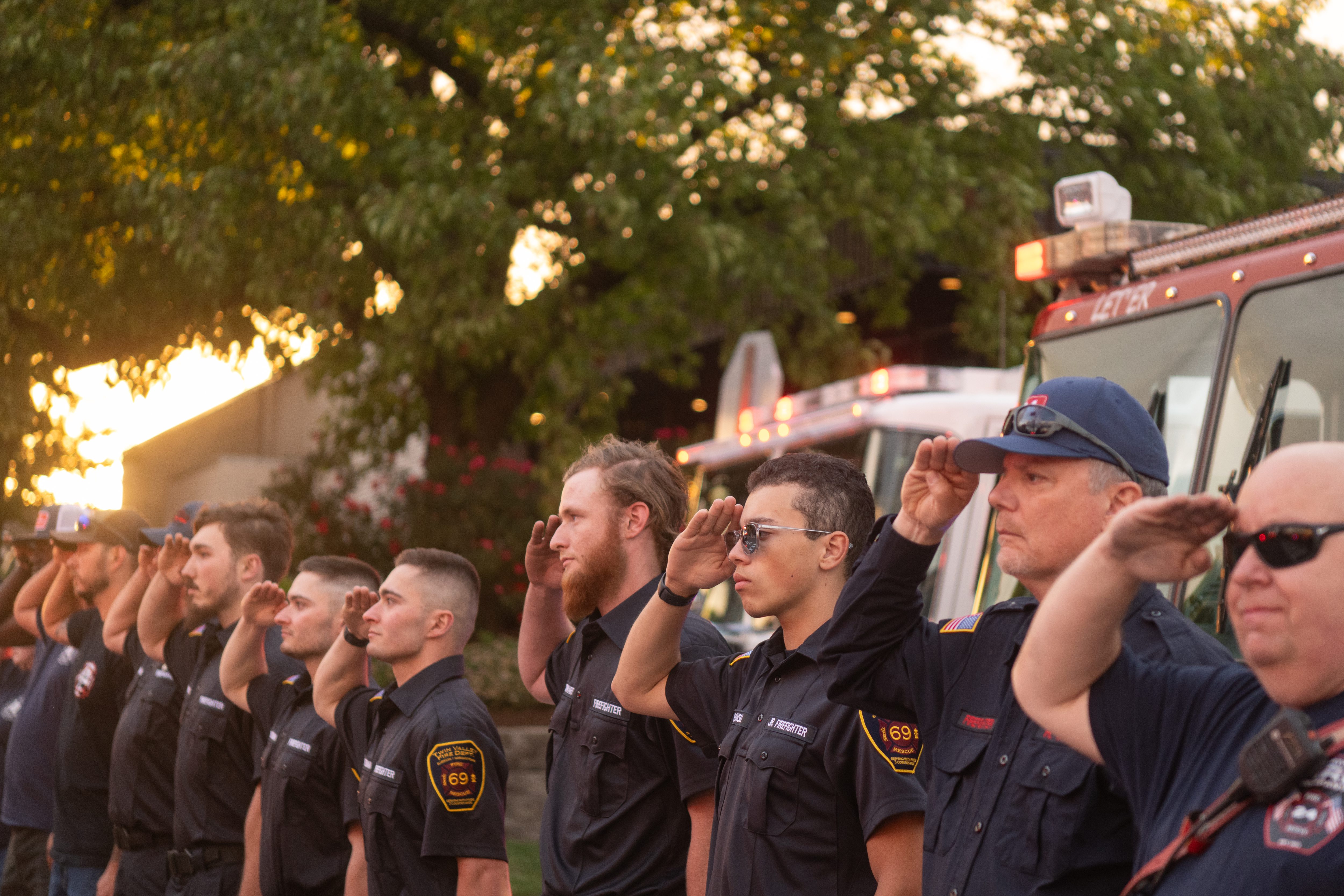 Firefighters from Twin Valley, Geigertown and other companies salute as...