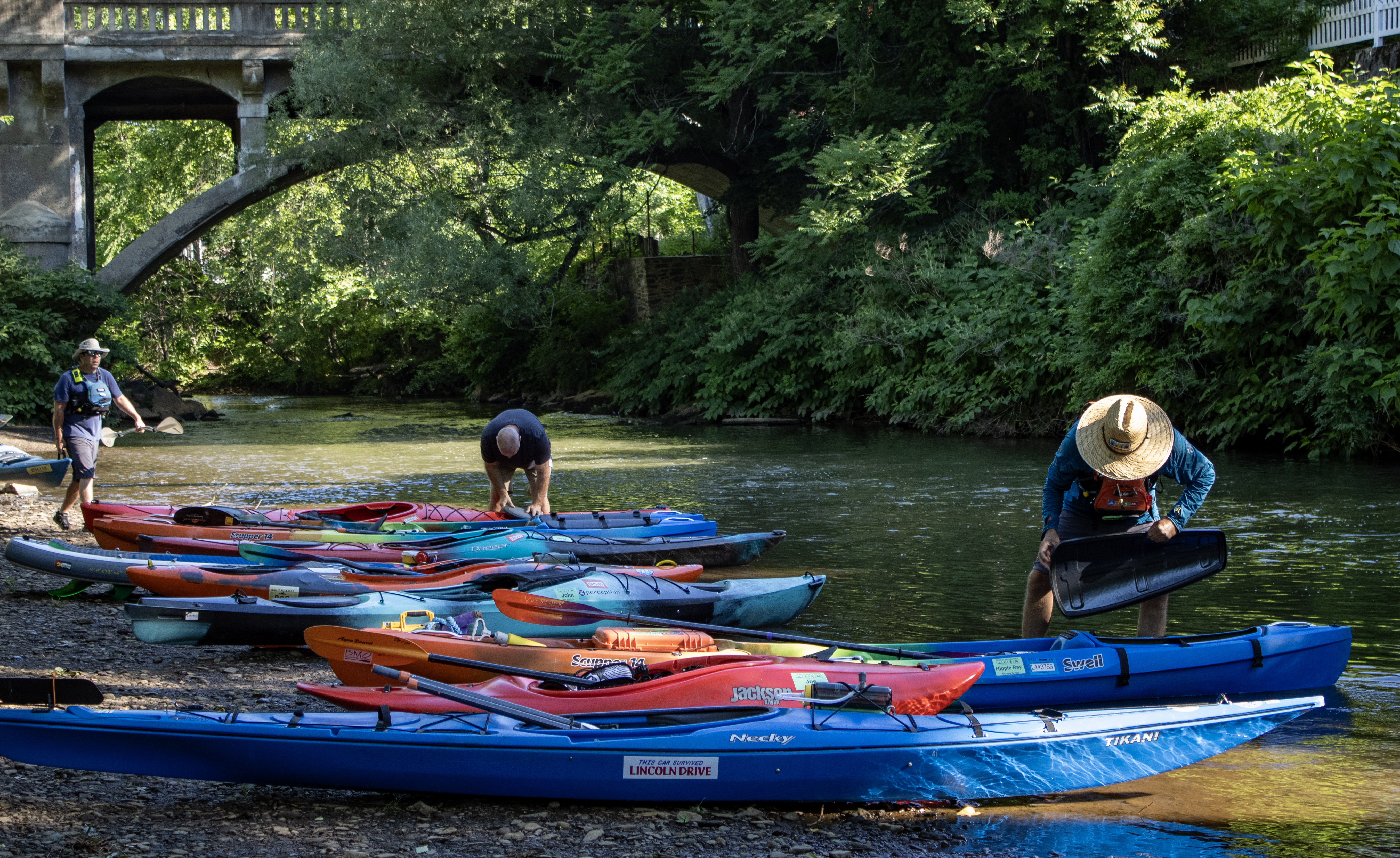 Canoes and kayaks gather at the starting area as paddlers...