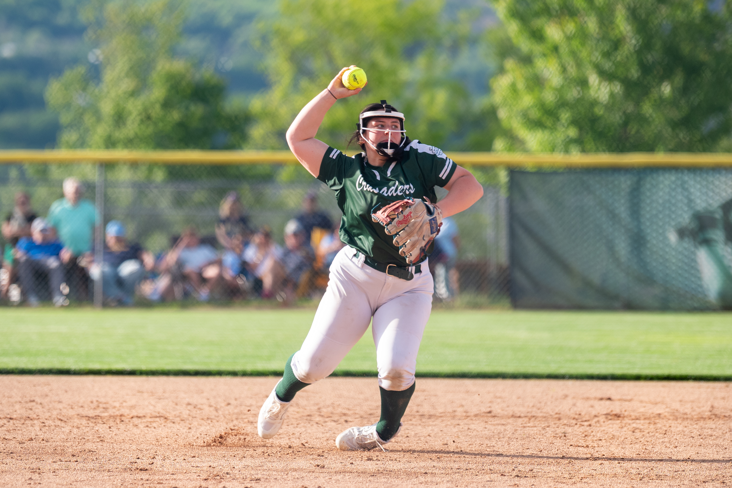 Holy Cross’ Jules Galella throws to first during the District...
