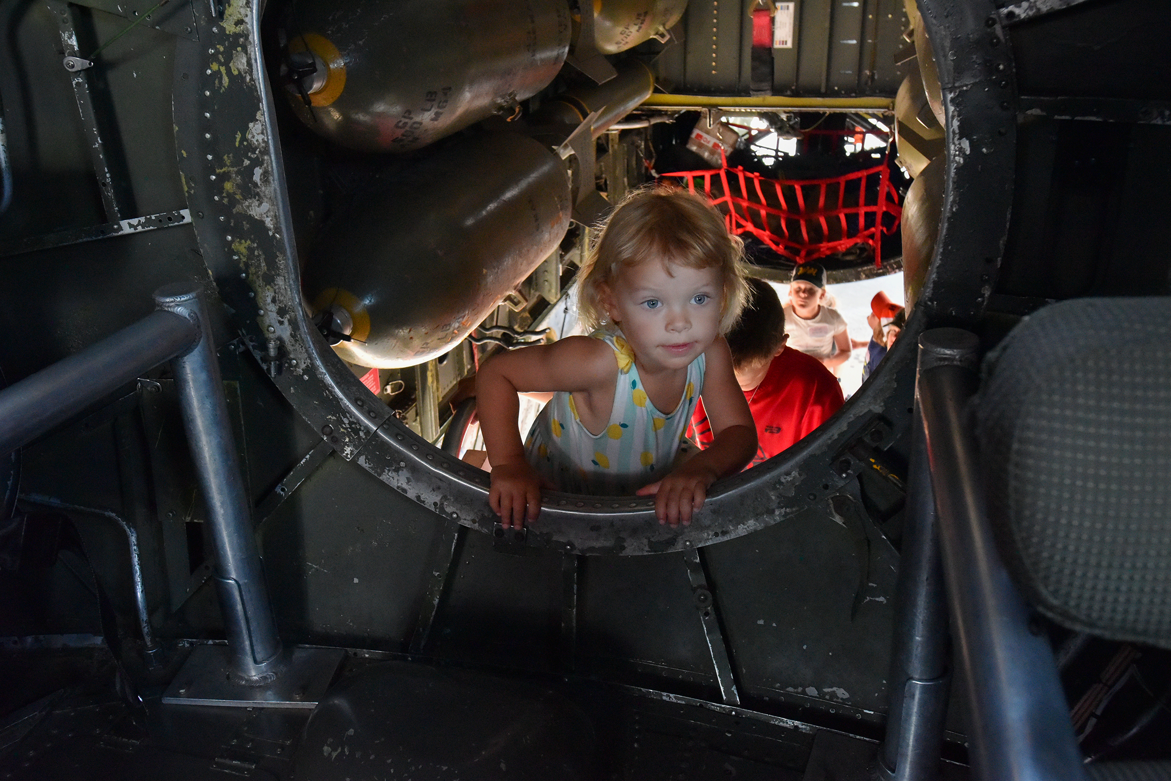 Lydia Florek, 2, of Mountain Top, climbs into the cockpit...