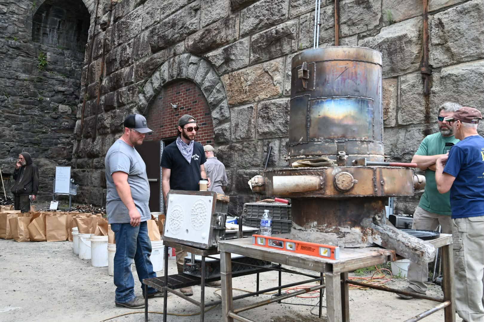 Volunteers demonstrate a furnace displayed at the Arts on Fire...