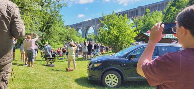 Those attending the historic crossing of the Big Boy 4014 across the Tunkhannock Viaduct, hold up cameras and cell phones in anticipation of the crossing on June 13, 2026. (GERI GIBBONS/STAFF PHOTO)