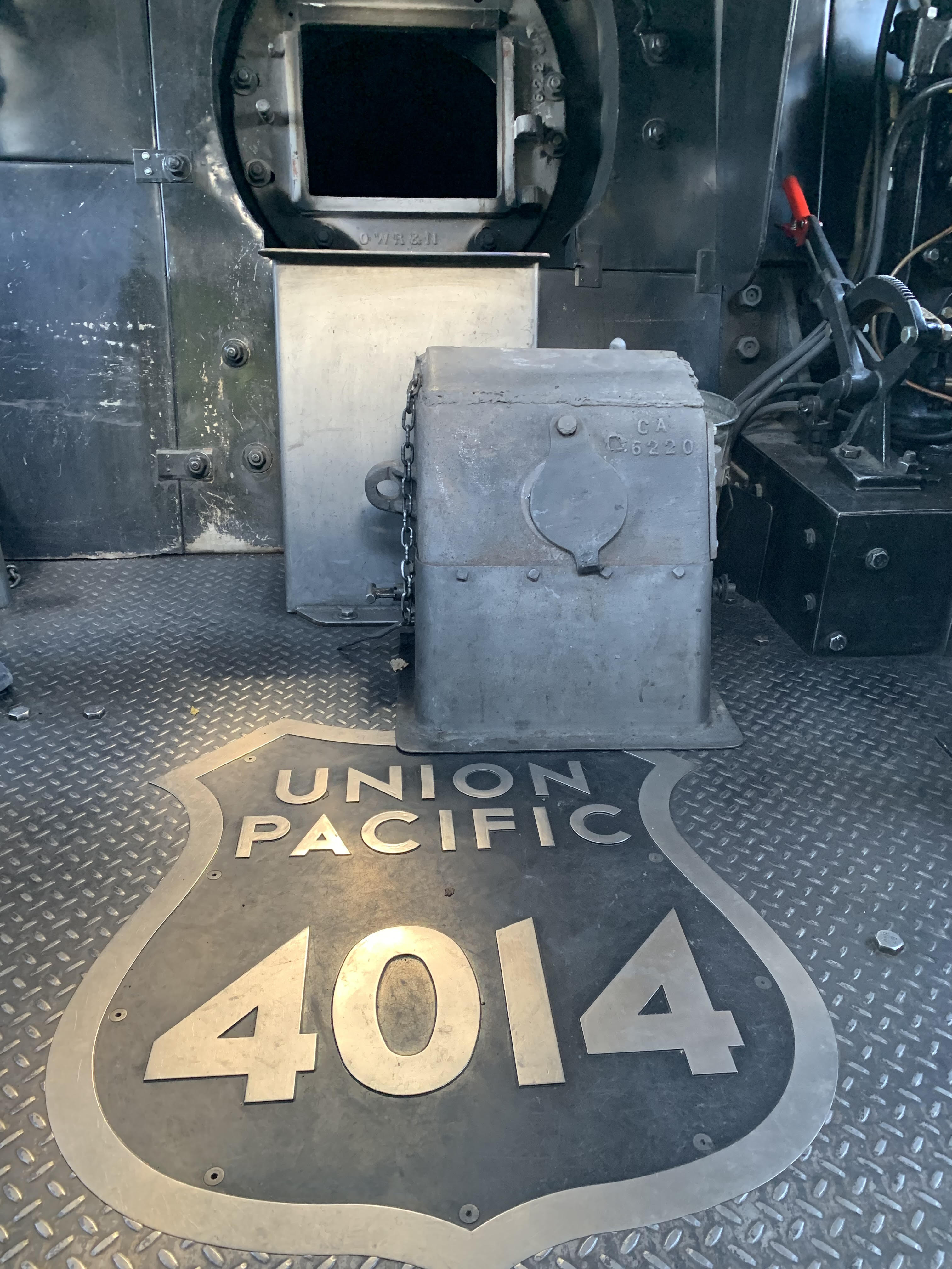 A Union Pacific logo on the floor below an open...