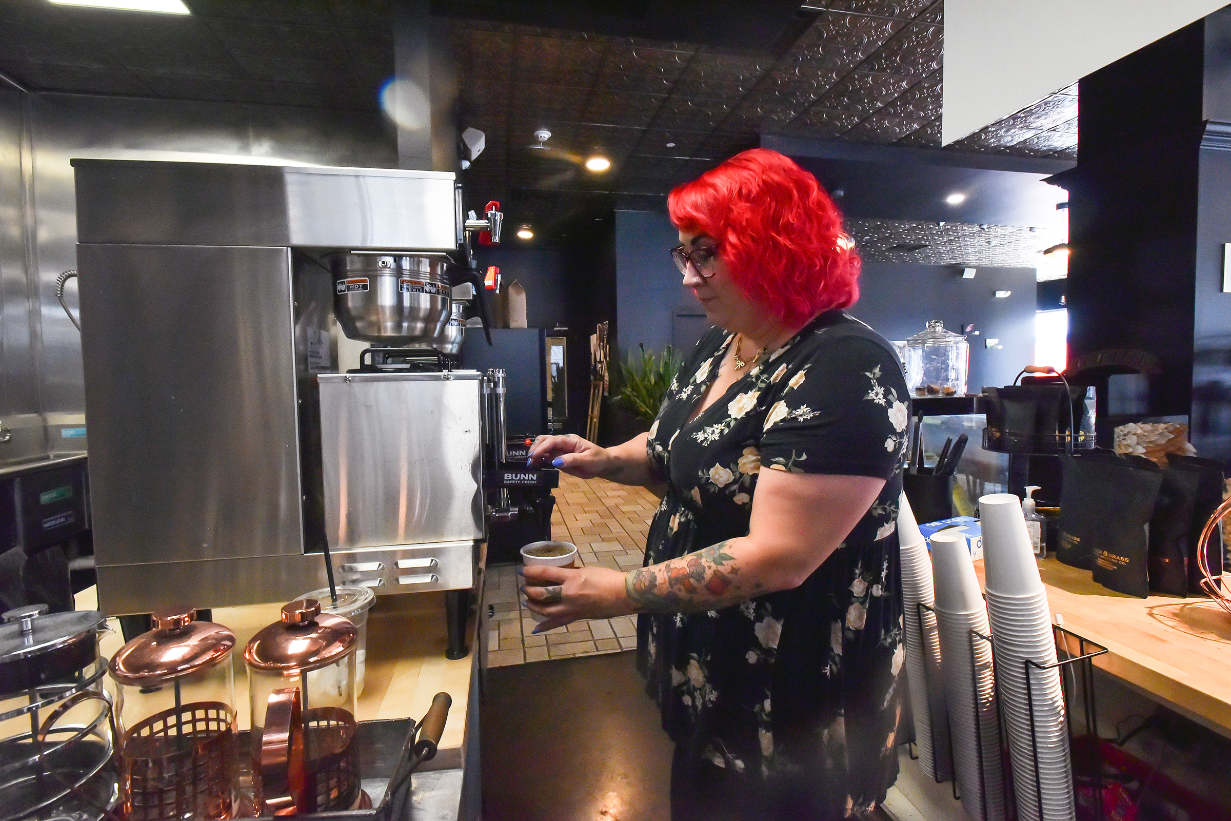 Manager Felicia Lee pours coffee for a customer at Black...