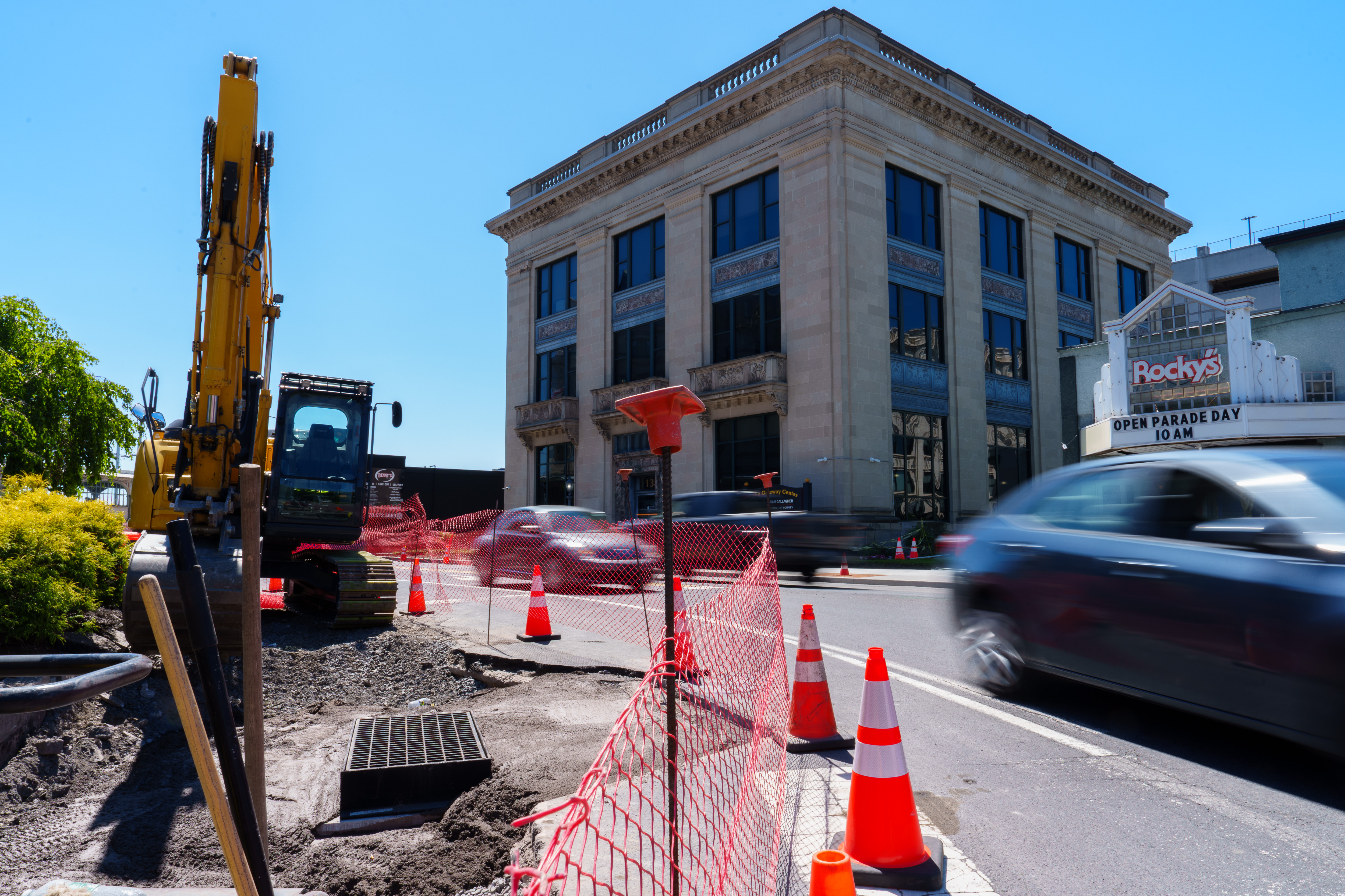 Cars drive past a construction site on the corner of...