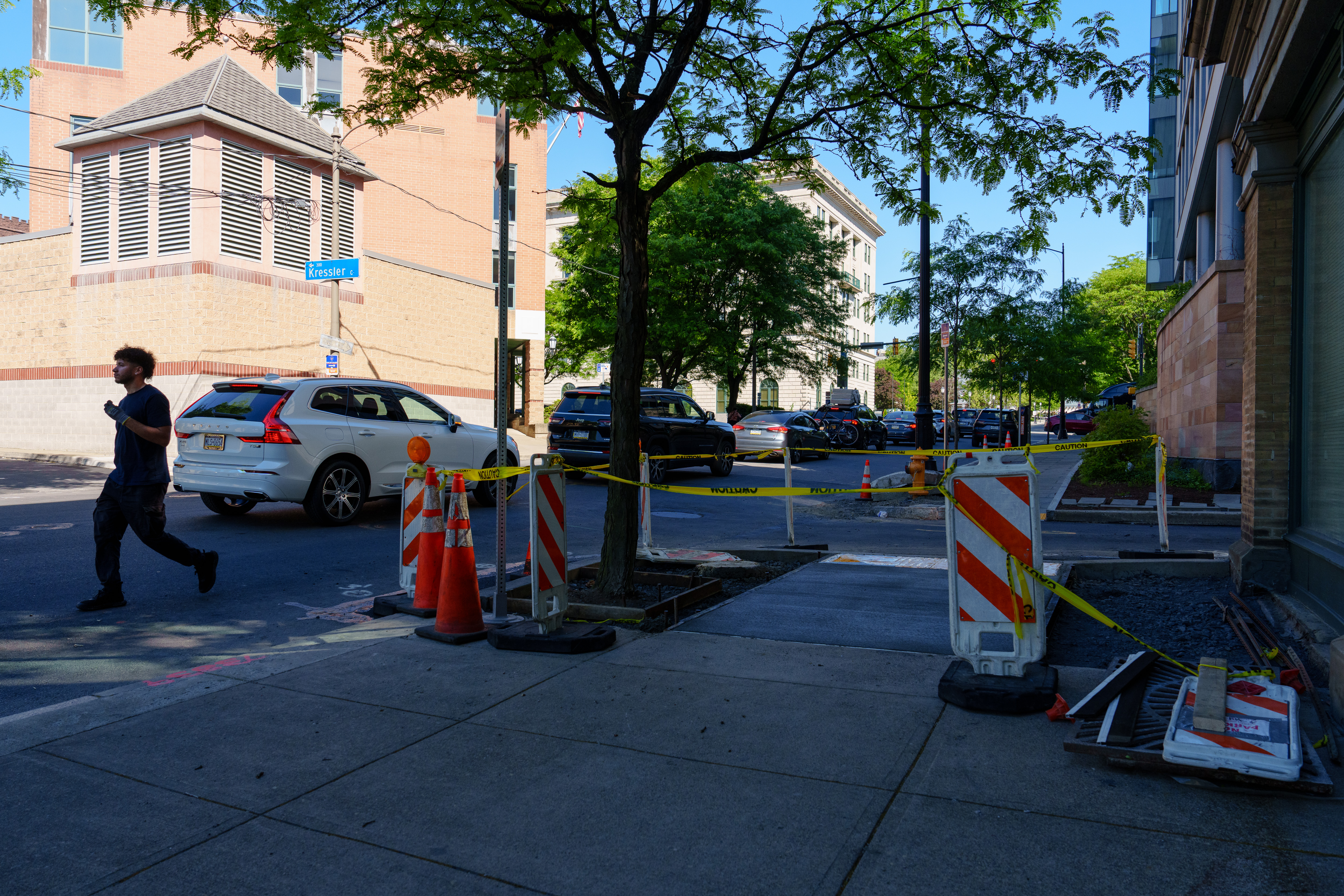A pedestrian walks on Linden Street as sections of the...