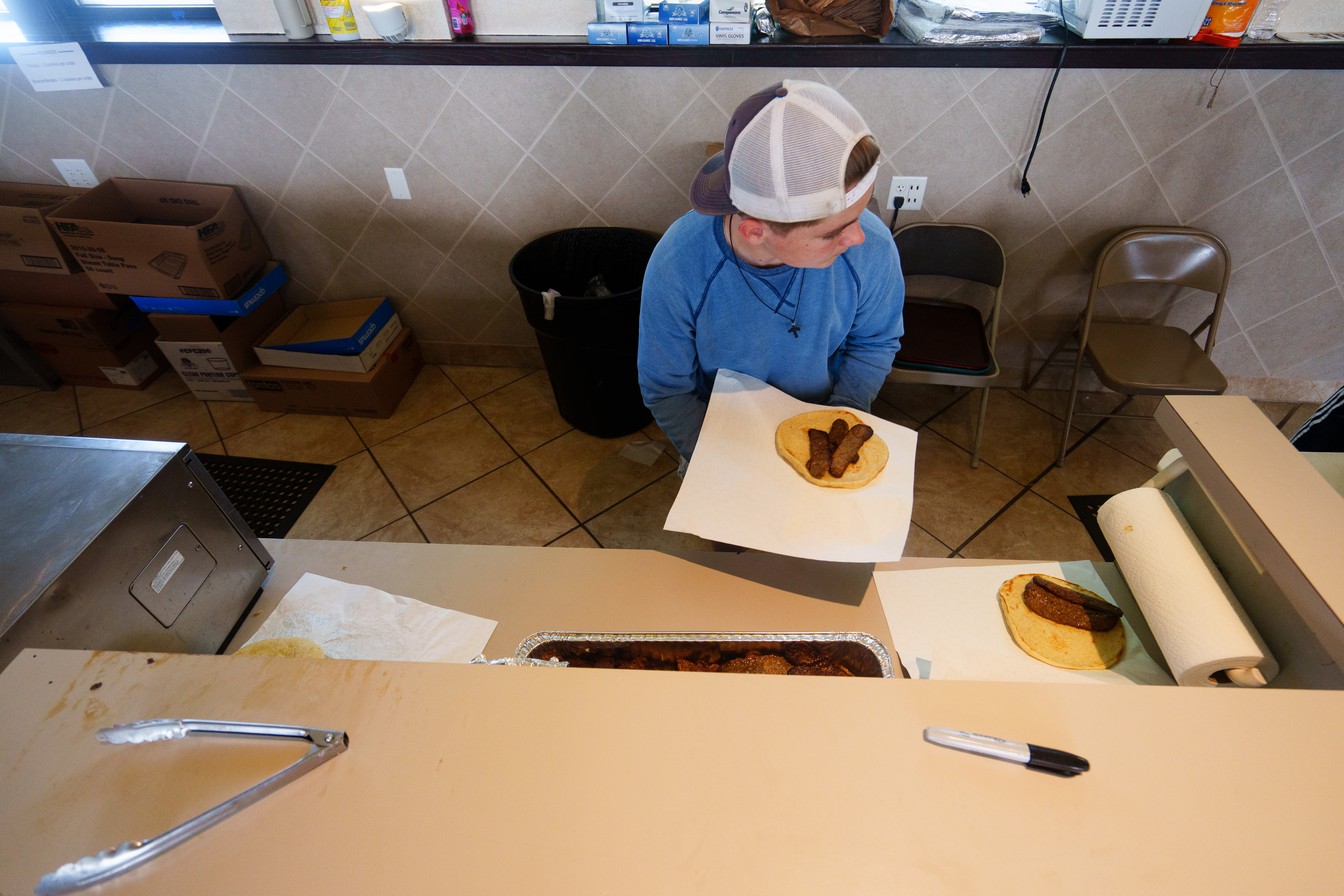 A worker prepares gyros at the Greek Food Festival at...