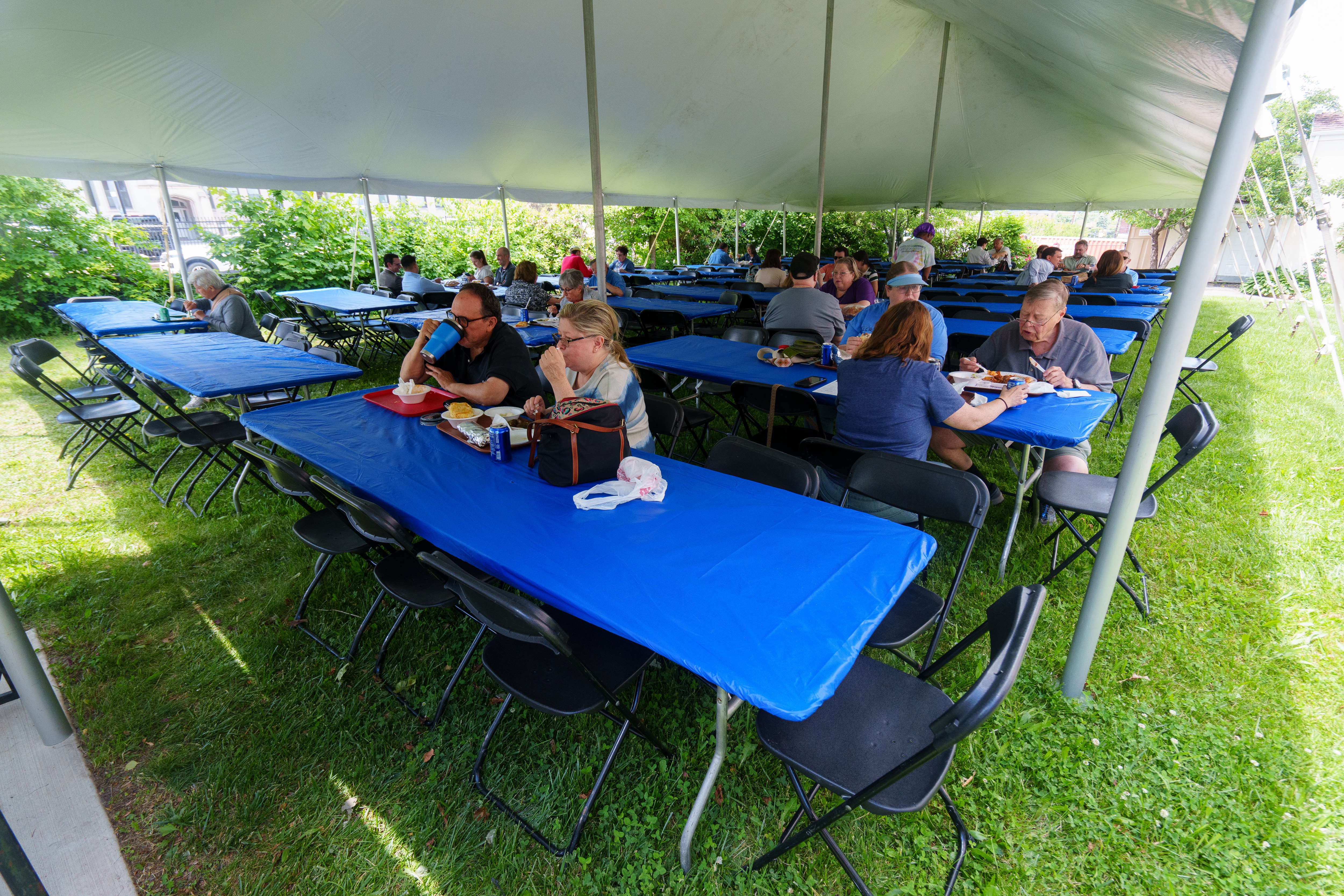 Customers eat in a tented dining area at the Greek...