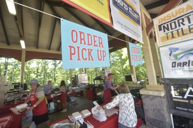 Visitors pick up food orders at the 2026 Jewish Food Festival, a four-day celebration of Jewish ethnic food at Nay Aug Park in Scranton from Sunday, June 28, through Wednesday, July 1, from 11:30 a.m. to 6:30 p.m. daily. (CHAD SEBRING/STAFF PHOTO)