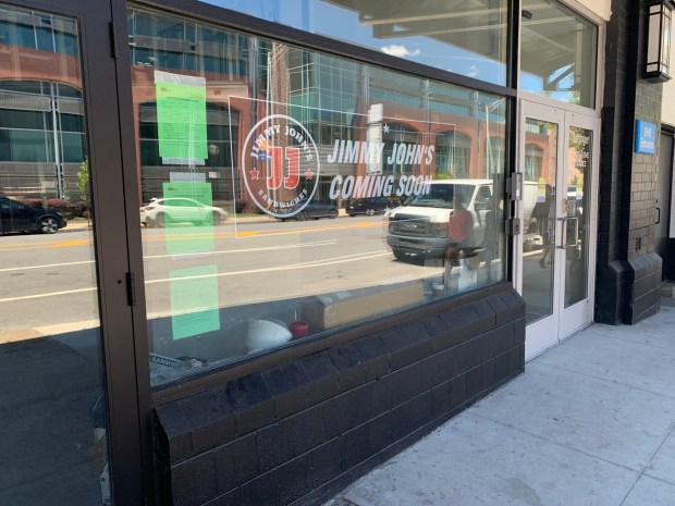 A sign in a storefront window at The Marketplace at Steamtown on Lackawanna Avenue in downtown Scranton on Tuesday, June 16, 2026 says a "Jimmy John's Sandwiches" shop is coming soon there. (JIM LOCKWOOD / STAFF PHOTO)