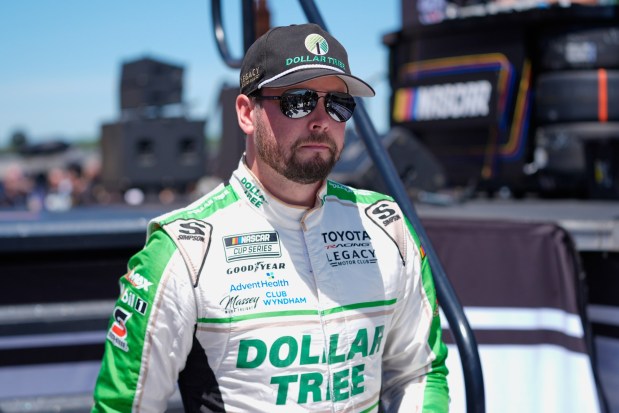 Erik Jones walks to his car before a NASCAR Cup Series race at Michigan International Speedway in Brooklyn, Mich., on June 7. Paul Sancya / Associated Press