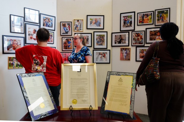 Attendees look at a photo installation during a Juneteenth open house at the Black Scranton Project Center for Arts & Culture in Scranton, Pa., on Friday, June 19, 2026. (ISAAC DIAZ/STAFF PHOTO)