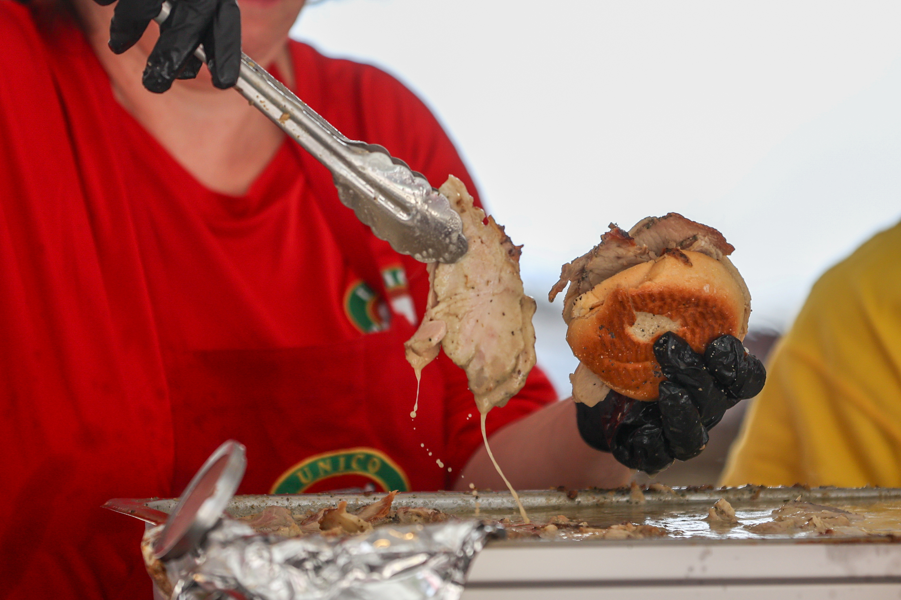 A porketta sandwich is assembled by a UNICO Scranton worker...