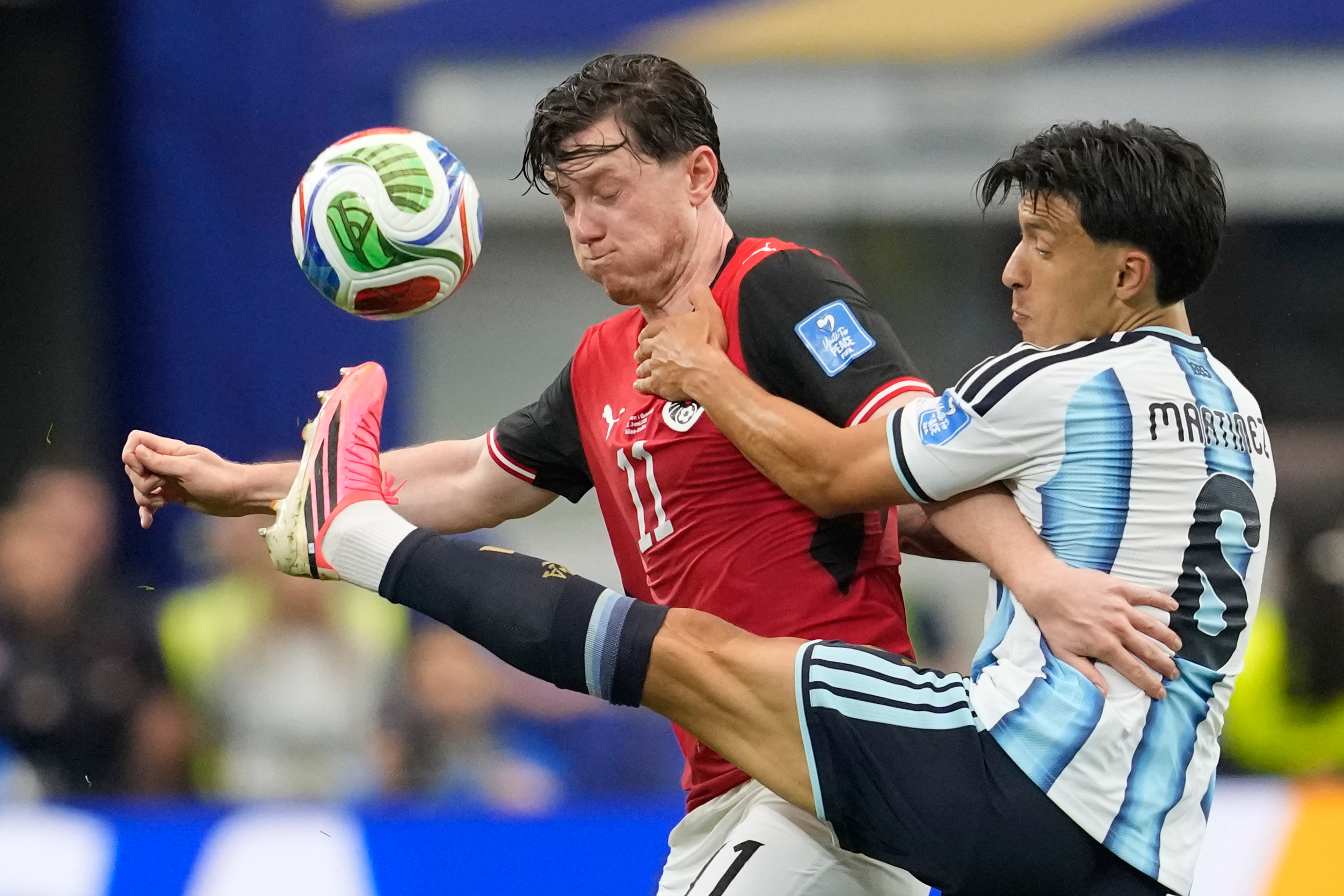 Austria’s Michael Gregoritsch (11) and Argentina’s Valentin Barco battle for...