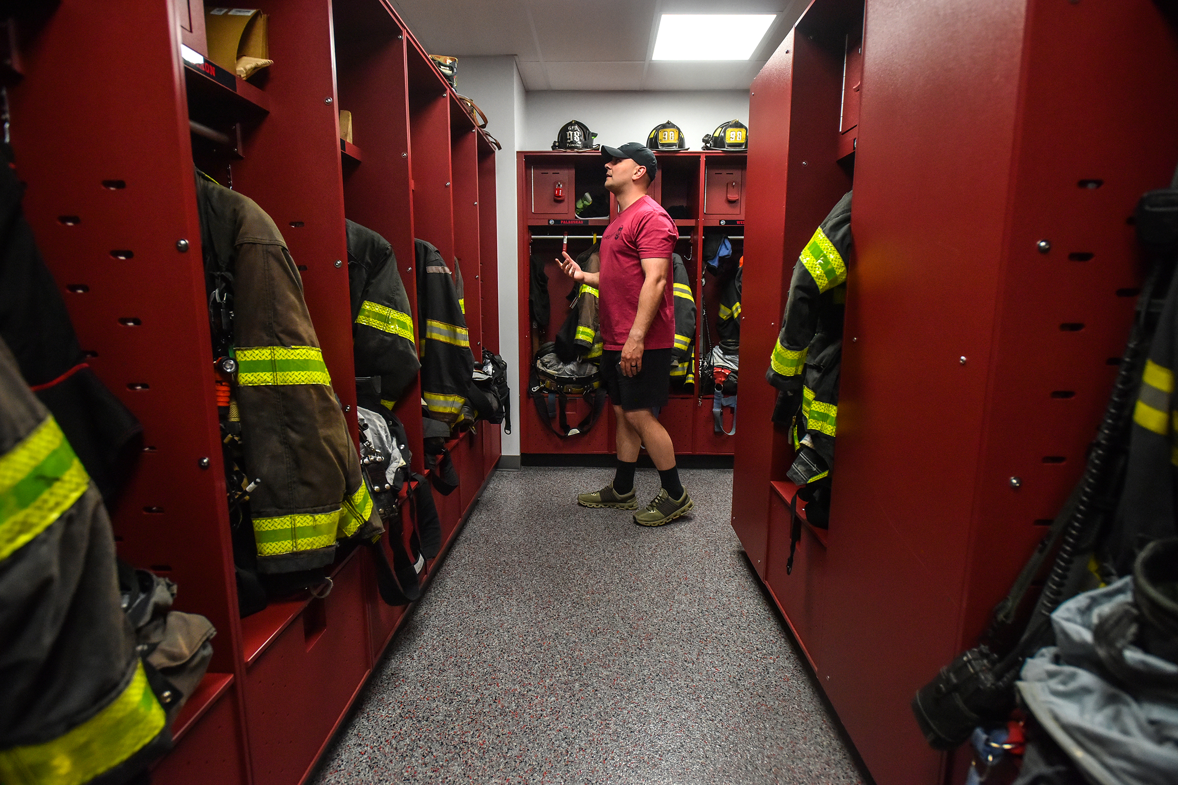 Volunteer fireman Ryan Joyce shows off the storage are for...