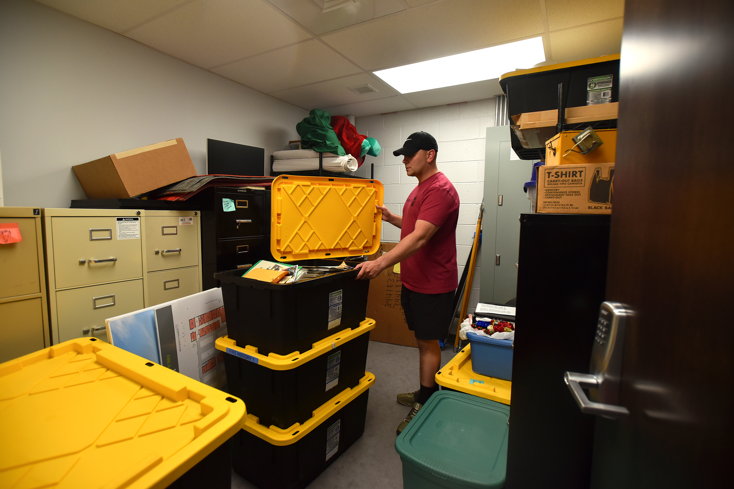 Volunteer fireman Ryan Joyce shows off additional storage space in...