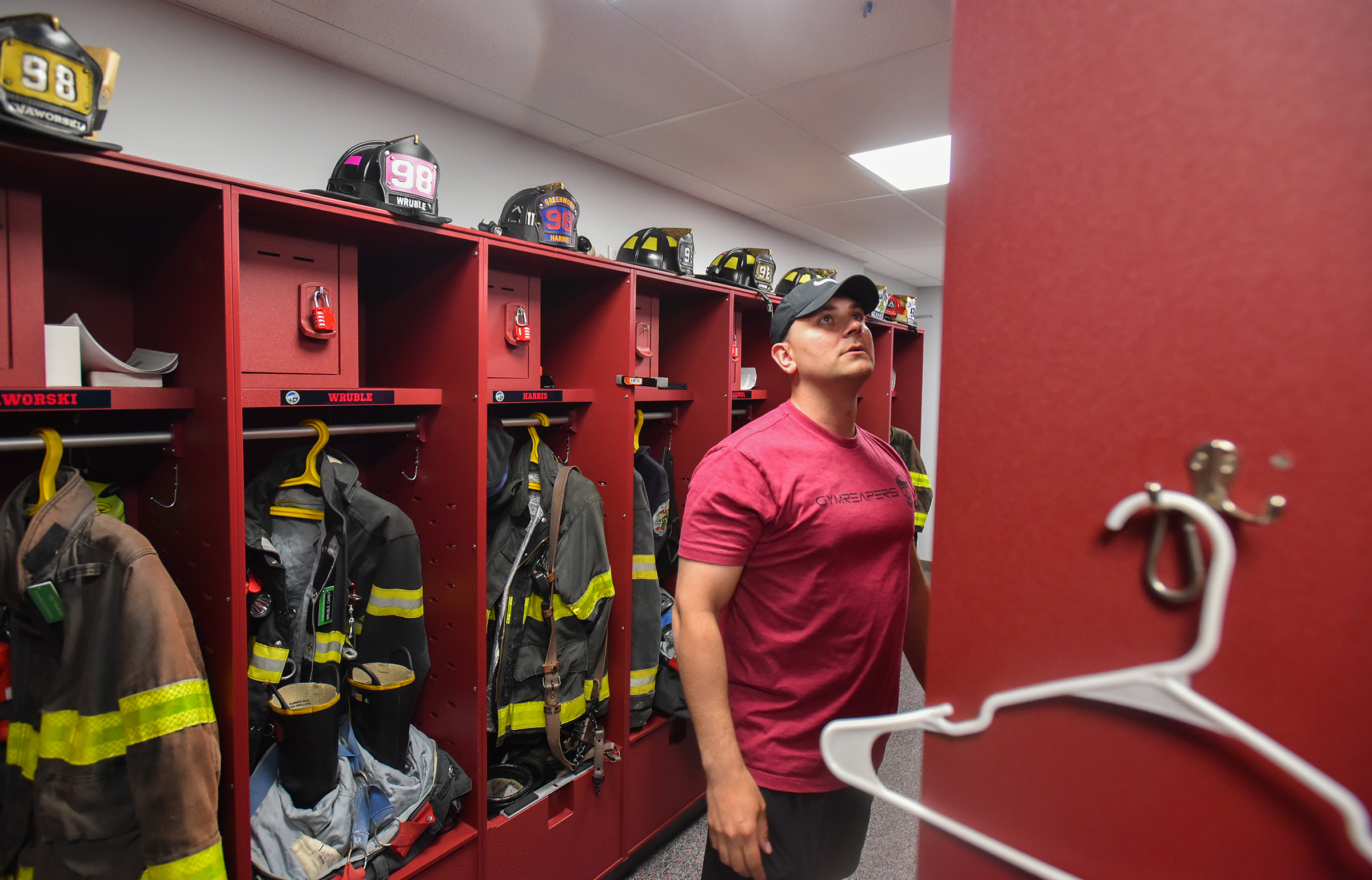 Volunteer fireman Ryan Joyce shows off a uniform storage area...