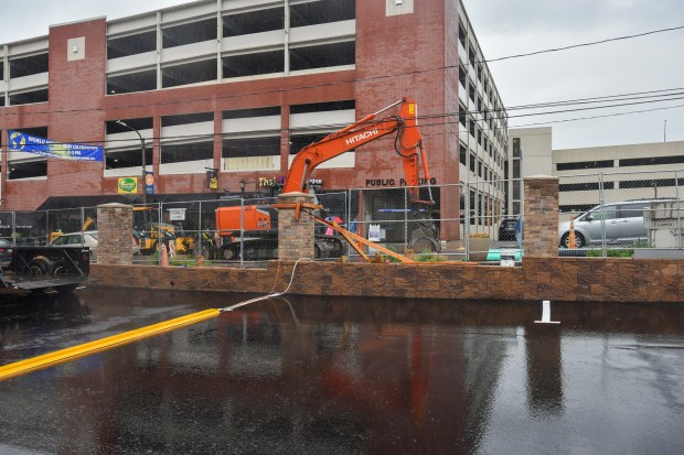 A stone wall is put up on the site on the former Mates and Mates property on the 300-block of N. Washington Ave. in downtown Scranton Monday, June 22, 2026. (SEAN MCKEAG / STAFF PHOTOGRAPHER)