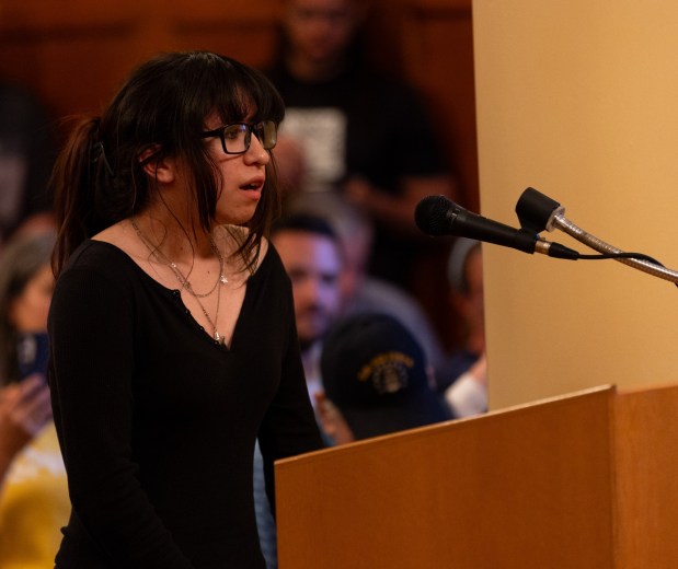 Sara Rosas of Honesdale cautions Olyphant officials, "I don't want to see my peers fall behind because they have to rely on machines, and I also don't want to see my home, the environment, be destroyed, and water sources to dry out because of these data centers," during a council meeting in the Municipal Building in Olyphant on Tuesday, June 9, 2026. (FRANK WILKES LESNEFSKY / STAFF PHOTO)