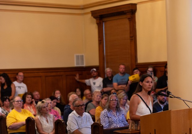 Olyphant resident Natalia Berjashi asks borough officials, "Will you allow data centers to scar this community, to rob this community, or will you fight for this community?" during a council meeting in the Municipal Building in Olyphant on Tuesday, June 9, 2026. (FRANK WILKES LESNEFSKY / STAFF PHOTO)