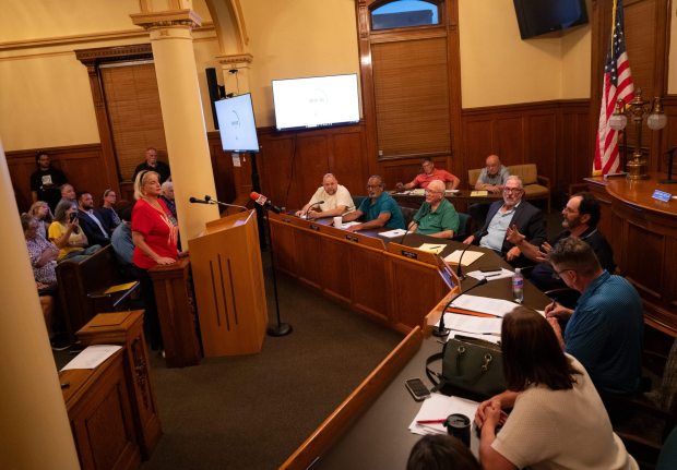Olyphant resident Lauren Telep engages with council President Jimmy Baldan, seated third from right, during a council meeting in the Municipal Building in Olyphant on Tuesday, June 9, 2026. (FRANK WILKES LESNEFSKY / STAFF PHOTO)