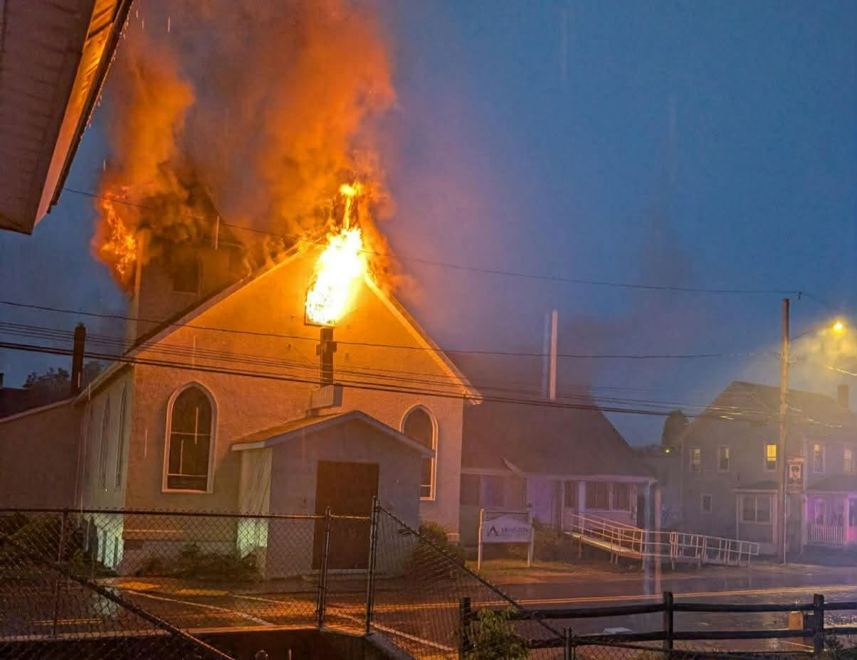 Firefighters fight flames at a church building in Peckville on...
