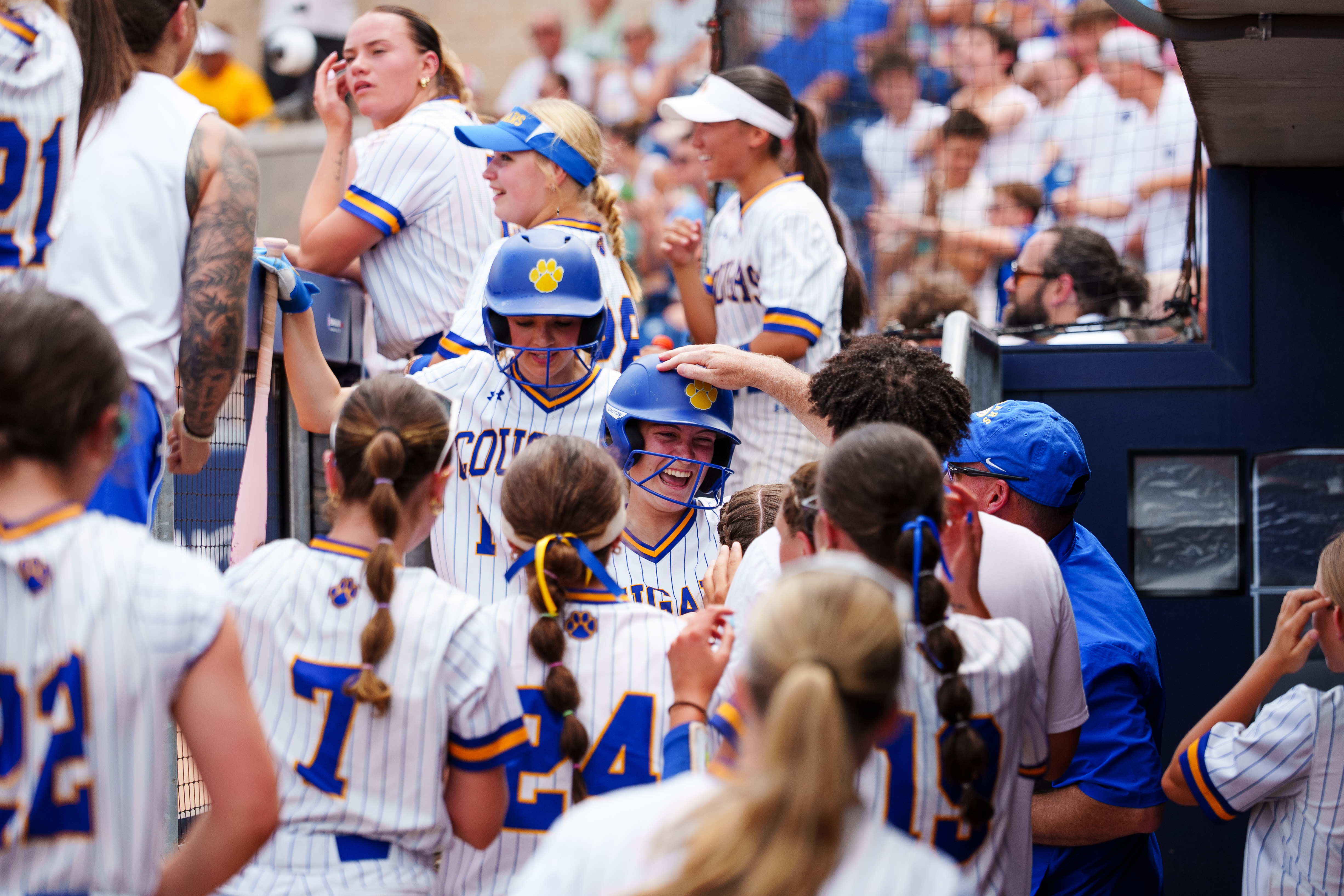 Valley View players celebrate with teammates returning to the dugout...