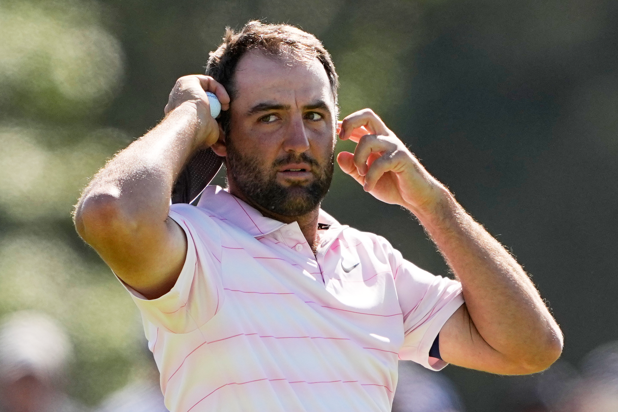 Scottie Scheffler waits to play on the eighth hole during...