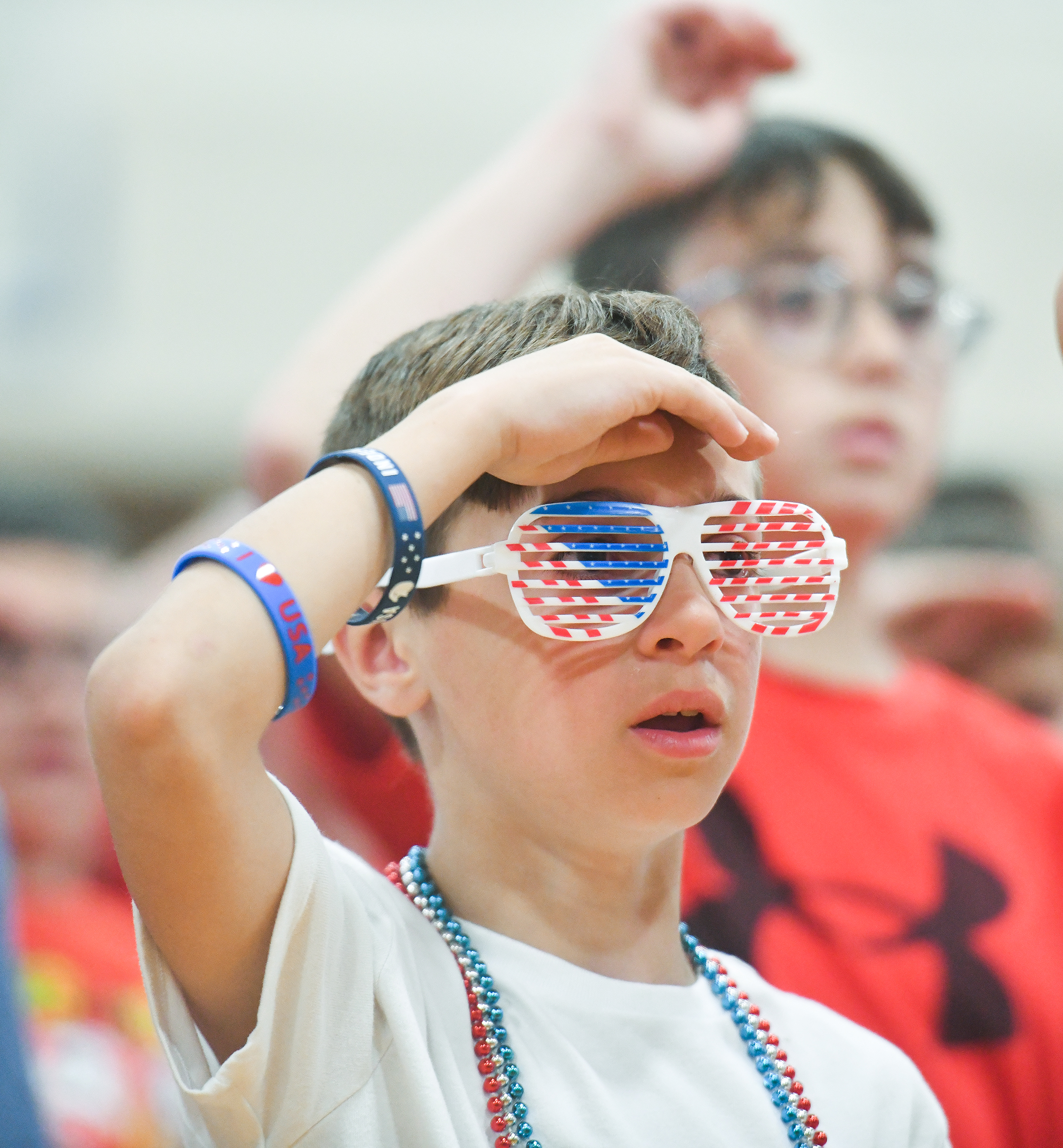 Third grader Logan Gilgallon sings “Proud to be an American”...