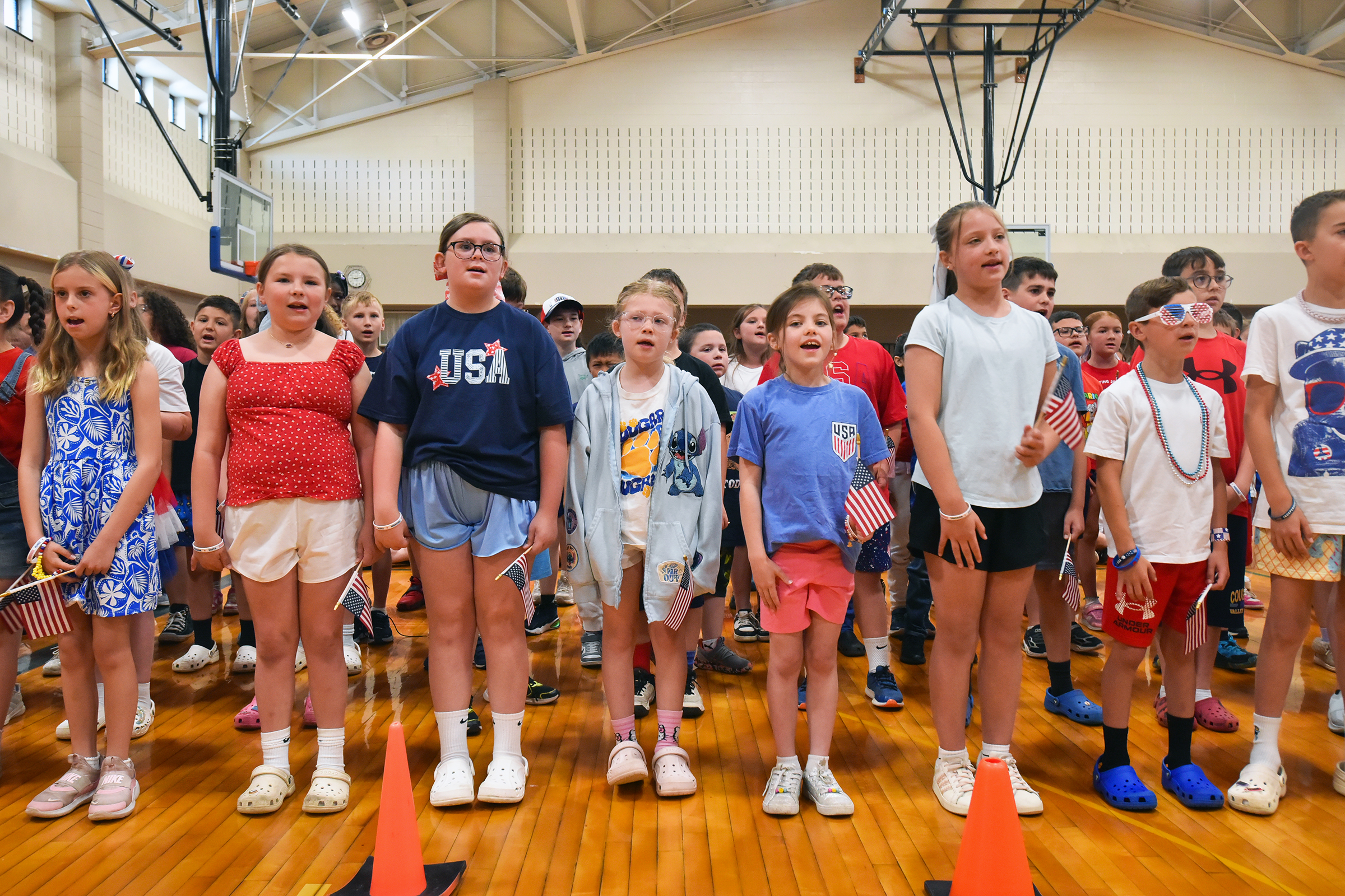 Third grade students sing “Proud to be an American” during...