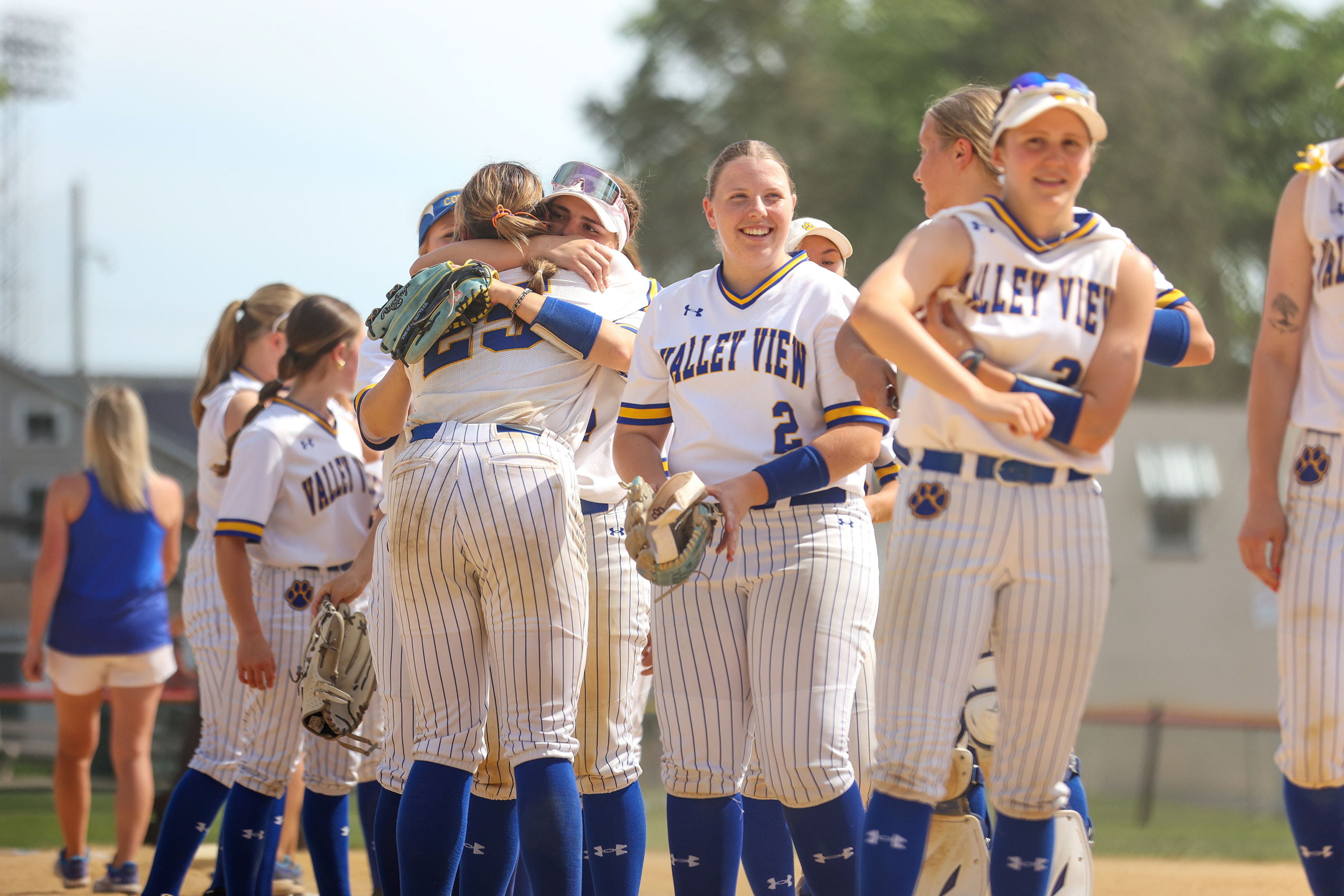 Valley View’s Zoie Krupovich (12) hugs teammate Abbi Call (25)...