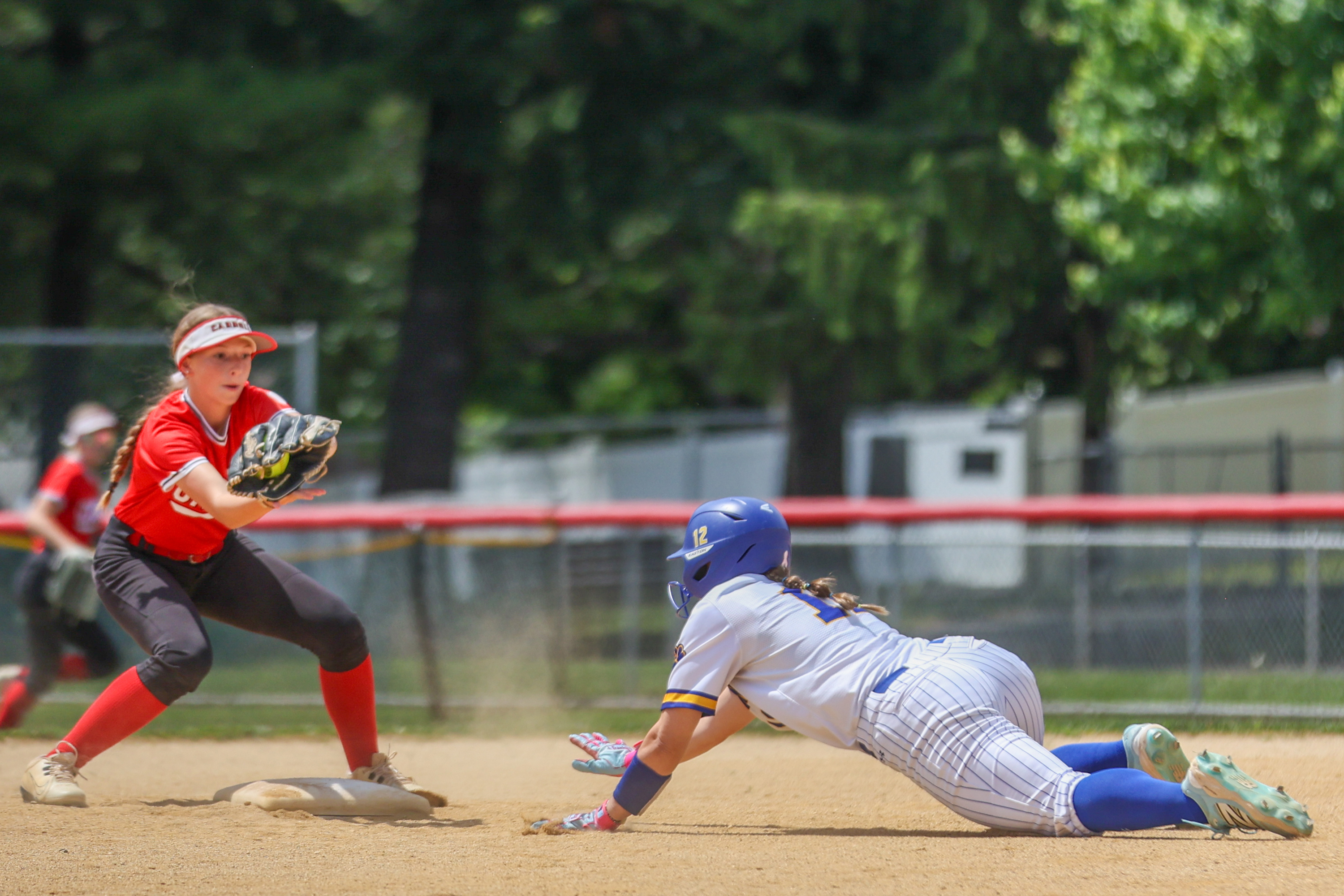 Valley View’s Zoie Krupovich (12) dives back to second base...