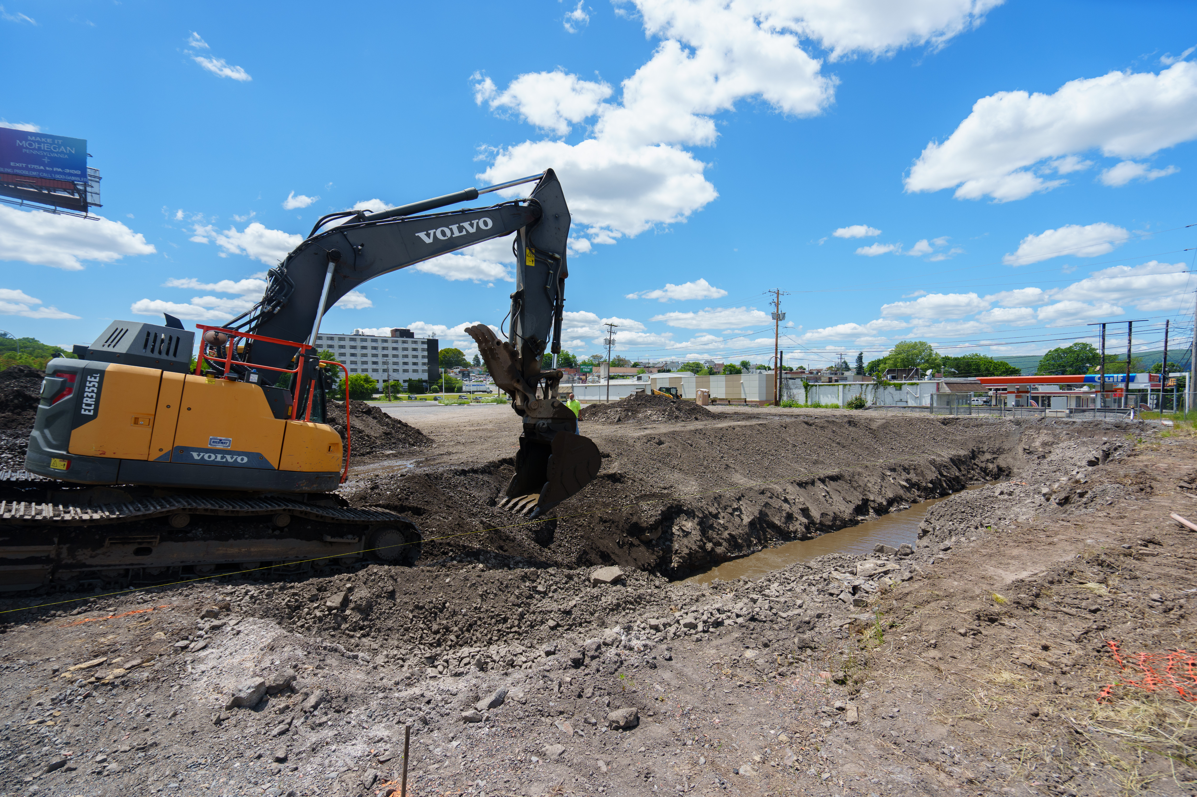 An excavator digs Monday at the site of a Wawa...