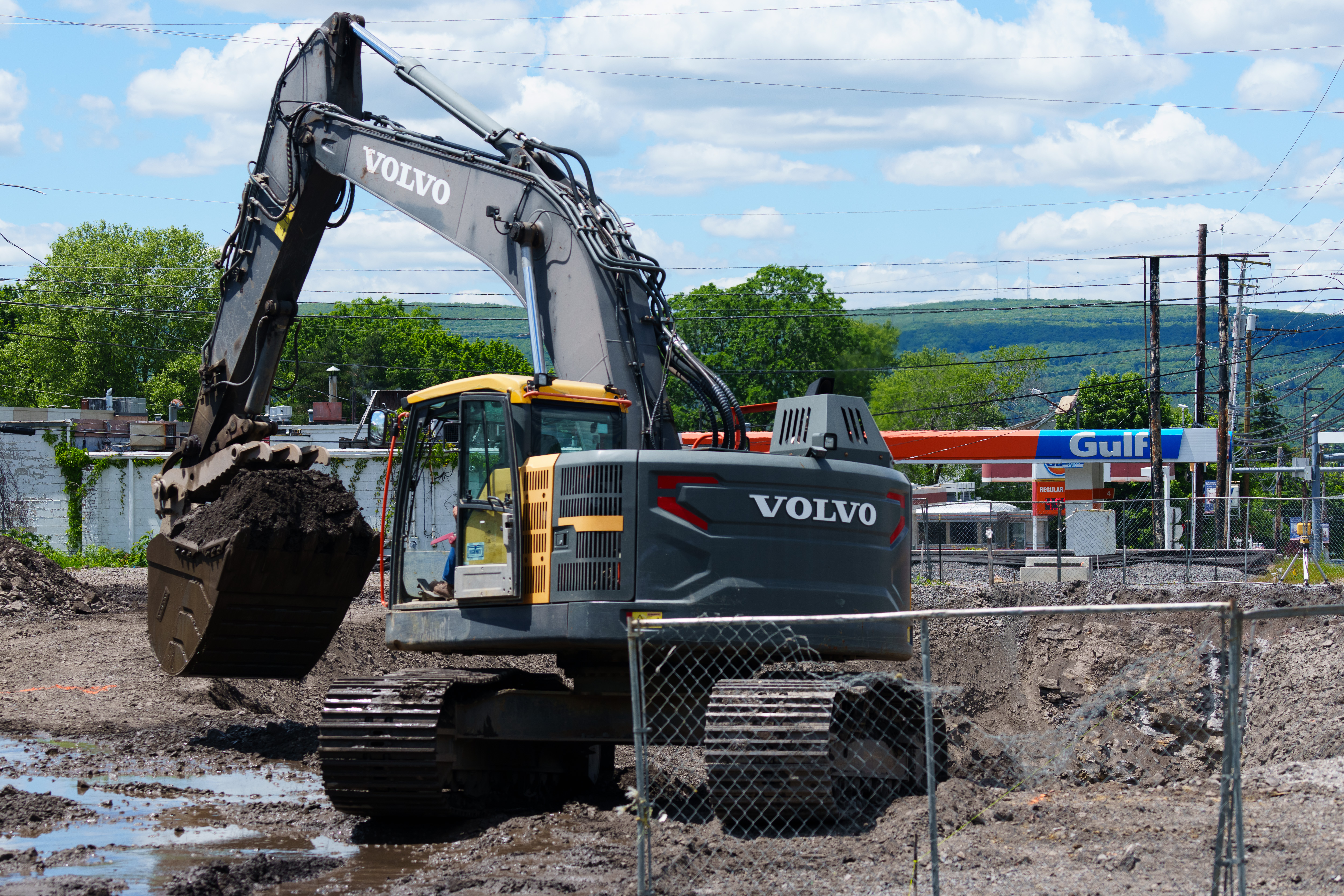 An excavator digs Monday at the site of a Wawa...