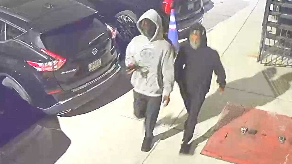 Two suspects walking down a street in Philadelphia