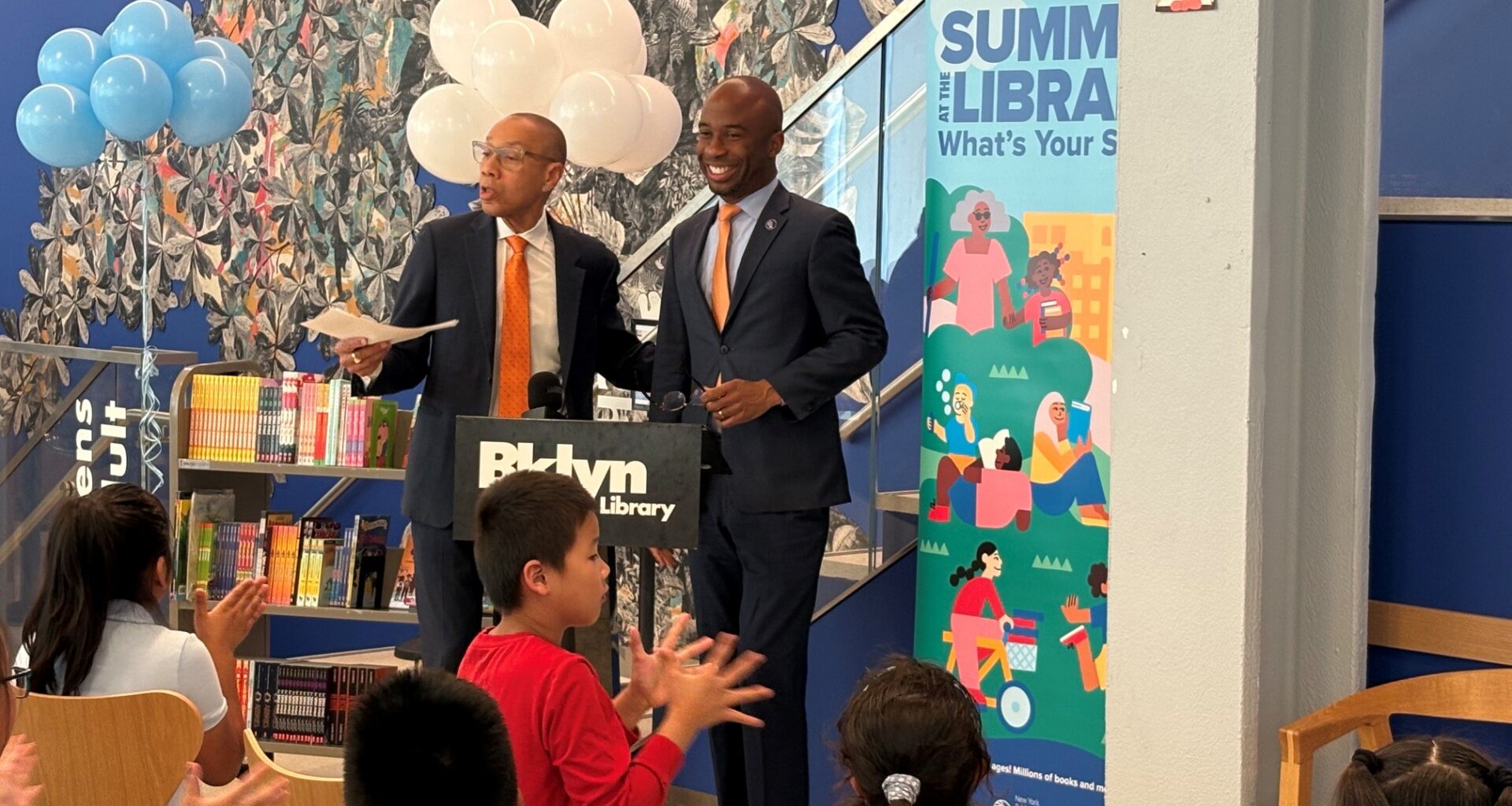 At the Sunset Park Library on Tuesday, Queens Public Library President & CEO Dennis Walcott, left, joined New York City Public Schools Chancellor Kamar Samuels to kick off the citywide “Summer at the Library” reading program. Photo: BPL
